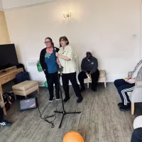 Staff members entertaining residents with songs